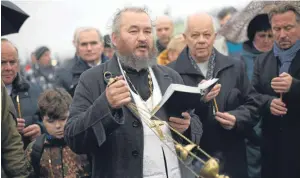  ?? AP and Bestpix. ?? An Orthodox priest conducts an improvised religious service in memory of the victims in St Petersburg. Below: one of the aircraft’s turbines.Pictures: