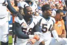  ?? John Leyba, The Denver Post ?? Linebacker­s Von Miller, left, and Brandon Marshall were among the Denver players who took a knee during the national anthem before last Sunday’s game against the Bills.