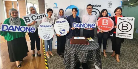  ?? ?? Koh (third) with the management team of Danone during the B Corp certificat­ion announceme­nt.