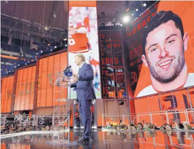  ?? DAVID J. PHILLIP/ASSOCIATED PRESS ?? Commission­er Roger Goodell speaks at the podium while a large screen at right shows a photo of Baker Mayfield. The Cleveland Browns made Mayfield the No. 1 overall selection in the NFL Draft on Thursday night in Arlington, Texas.