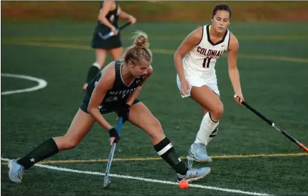  ?? MEDIANEWS GROUP PHOTO ?? Methacton’s Alexa Kratz, left, tries to hit the ball past the outstretch­ed stick of Plymouth Whitemarsh’s Ava Borkowski.