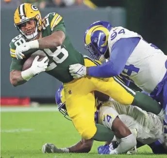  ?? MARK HOFFMAN/MILWAUKEE JOURNAL SENTINEL ?? Packers running back AJ Dillon proved tough for the Los Angeles Rams’ defense to bring down Sunday at Lambeau Field.