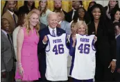  ?? EVAN VUCCI — THE ASSOCIATED PRESS ?? President Joe Biden and first lady Jill Biden are presented with jerseys by LSU women's basketball team captains Angel Reese, right, and Emily Ward, left, during an event to honor the 2023NCAA national championsh­ip team in the East Room of the White House on Friday in Washington.