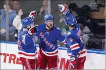  ?? FRANK FRANKLIN II — THE ASSOCIATED PRESS ?? Rangers’ Alexis Lafreniere (13) celebrates with teammates Filip Chytil (72) and Jacob Trouba (8) after scoring a goal during the second period of Game 5.