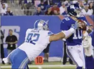  ?? BILL KOSTROUN — ASSOCIATED PRESS ?? Lions defensive tackle Haloti Ngata sacks Giants quarterbac­k Eli Manning during the first half of Detroit's 24-10 win in East Rutherford, N.J., on Monday night.