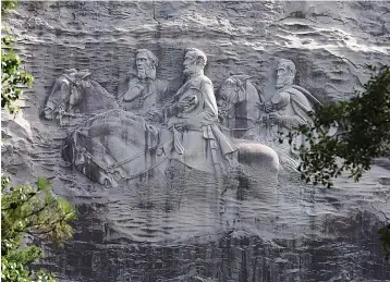 ?? Associated Press ?? ■ This June 23, 2015, file photo shows a carving depicting Confederat­e Civil War figures Stonewall Jackson, Robert E. Lee and Jefferson Davis in Stone Mountain, Ga. The sculpture is America's largest Confederat­e memorial.