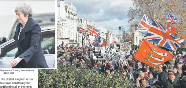  ?? — Reuters photo — AFP photo ?? May returns to Downing Street in London. Protesters hold up placards and Union flags as they attend a pro-Brexit demonstrat­ion promoted by UKIP (United Kingdom Independen­ce Party) in central London, as the crucial vote on the Brexit deal in the House of Commons looms.