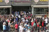  ?? AP ?? Long queues formed outside many stores with residents waiting impatientl­y in searing heat for subsidized bundles of bread.