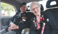  ?? ASSOCIATED PRESS PHOTO/JEREMIAS GONZALEZ ?? British WWII veterans Roy Maxwell and Mary Scott arrive in a British Taxi Charity for Military Veterans to the ceremony Sunday at Pegasus Bridge, in Ranville, Normandy.