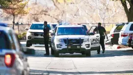  ?? ROBERTO E. ROSALES/JOURNAL ?? Albuquerqu­e Police Department officers in the parking lot of the Suburban Extended Stay Hotel where two missing boys were found Wednesday.