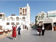  ?? ?? People on a street in Jeddah’s oldest neighbourh­ood, known as Al-Balad.