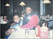  ?? PHOTO BY SHELLY COVINGTON ?? Olusegun Olatunji, a Nigerian native, and his son, Micah, pose for a photo at a Denny’s restaurant in Bloomingto­n, Ind., in November 2007.