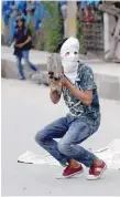  ?? Reuters ?? A masked protester prepares to throw a rock towards the police during a protest in Srinagar on Friday. —