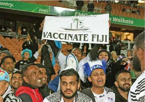  ?? ?? Fans at the Fiji vs All Blacks test in Hamilton, New Zealand, in July display a sign promoting COVID-19 vaccinatio­ns.