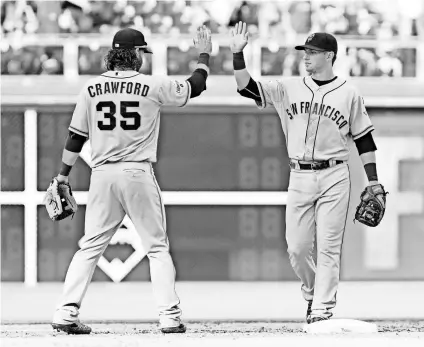  ?? BILL STREICHER, USA TODAY SPORTS ?? Shortstop Brandon Crawford, left, and second baseman Joe Panik give the Giants a strong middle infield, defensivel­y and offensivel­y.