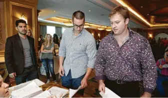  ??  ?? Eddie Mendoza, from left, Ashton Cali and Derrick Ricketts, all of Houston, check in.