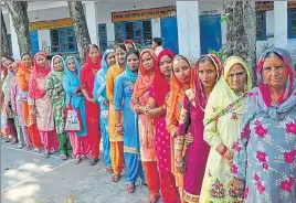  ?? HT PHOTO ?? Women outside a polling centre in Kangra district on Monday.