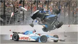  ?? PHOTOS BY RON GRAPHMAN/THE INDIANAPOL­IS STAR (ABOVE) AND CHRIS GRAYTHEN/GETTY IMAGES ?? Above: In a scary crash, pole-sitter Scott Dixon (9) went airborne and hit a retaining wall after striking the car of Jay Howard (77) coming out of turn one. Both drivers walked away from the wreck. At left: Takuma Sato of Japan celebrates after...