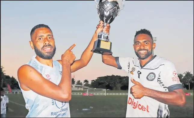  ?? Picture: FIJI FA MEDIA ?? Suva’s goal scorers Samuela Drudru and Malakai Rakula hoist the Digicel Fiji FACT trophy after beating Labasa 2-0 in the final at Lawaqa Park in Sigatoka on Sunday.
