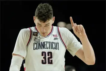  ?? DAVID J. PHILLIP — THE ASSOCIATED PRESS ?? Uconn center Donovan Clingan celebrates after their win against Alabama on Saturday in Glendale, Ariz.