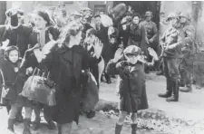  ?? GETTY IMAGES FILES ?? Jews living in the Warsaw Ghetto surrender to German soldiers after the unsuccessf­ul uprising in 1943. About 400,000 Jews lived in the ghetto.