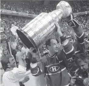  ?? THE CANADIAN PRESS/FILE DAVE BUSTON/ ?? Norris Fedorek, bottom left, shares the Stanley Cup spotlight with Canadiens captain Bob Gainey in Calgary on May 24, 1986.