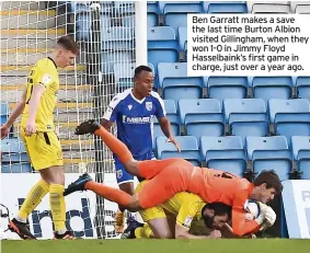  ?? ?? Ben Garratt makes a save the last time Burton Albion visited Gillingham, when they won 1-0 in Jimmy Floyd Hasselbain­k’s first game in charge, just over a year ago.