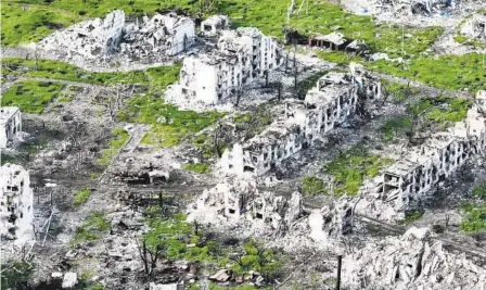  ?? LIBKOS VIA AP ?? In an aerial view taken Thursday, razed buildings and shell craters in Maryinka, Ukraine, show the devastatio­n from recent battles.