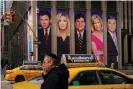  ?? Photograph: Drew Angerer/ Getty Images ?? Images of Fox News personalit­ies including Tucker Carlson adorn the front of the News Corporatio­n building in New York in March 2019.