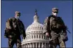  ?? ANDREW HARNIK — THE ASSOCIATED PRESS ?? Members of the National Guard walk past the Dome of the Capitol Building on Capitol Hill in Washington on Thursday.