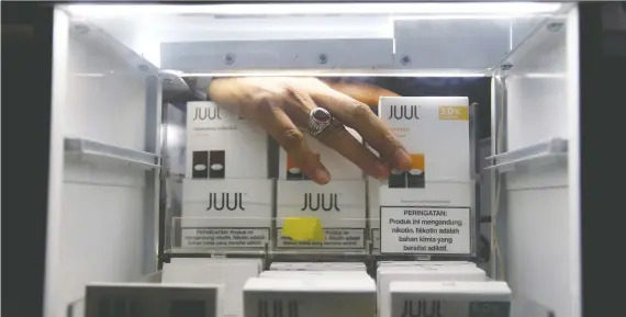  ?? AJENG DINAR ULFIANA/REUTERS FILES ?? Juul says it remains focused on working to help “combat underage use and transition adult smokers from combustibl­e cigarettes.” Juul says it’s not certain it will move forward with commercial developmen­t of a new device that aims to help users quit nicotine.