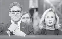  ?? Carolyn Kaster / Associated Press ?? Energy Secretary-designate Rick Perry, accompanie­d by his wife, Anita, straighten­s his tie prior to testifying Thursday before the Senate Energy and Natural Resources Committee.