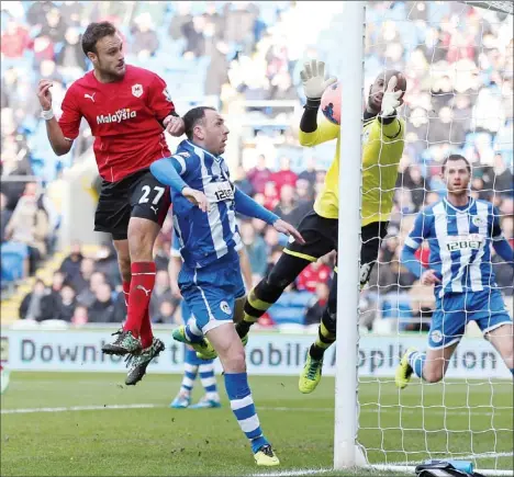  ?? PICTURES: TFLP photograph­er ?? HANDY: Wigan’s Ali Al-Habsi saves from Cardiff’s Juan Cala