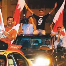  ?? Reuters ?? Bahrainis celebrate in Manama on October 25, 2002 after parliament­ary elections. The elections were the first to be held after the national charter was approved.