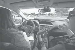  ?? NICK OZA/THE REPUBLIC ?? Driver Priscilla Knox and Jaime Waydo, a Waymo engineer, demonstrat­e a self-driving car.