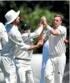  ?? PHOTO: GETTY IMAGES ?? Tim Southee is congratula­ted by teammates after claiming his 200th test wicket.