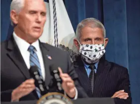  ?? SUSAN WALSH/AP ?? Dr. Anthony Fauci, right, director of the National Institute of Allergy and Infectious Diseases, listens as Vice President Mike Pence speaks during a news conference with the Coronaviru­s task force Friday in Washington, D.C.