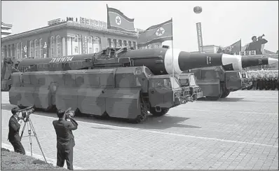  ?? AP/WONG MAYE-E ?? Missiles roll through Kim Il Sung Square during a military parade Saturday in Pyongyang, North Korea. Military experts said they appeared to be KN-08 interconti­nental ballistic missiles, one of three kinds of ICBMs spotted during the parade.