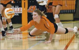 ?? JOEL ROSENBAUM – THE REPORTER ?? Vacaville High’s Elyse McKinney dives on the floor to make a dig during the third game of its victory over Vanden High Thursday at Vaca High.