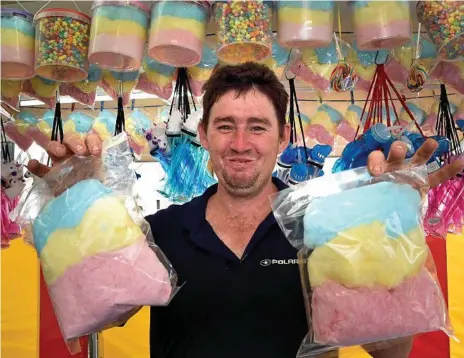  ?? Photos: Bev Lacey ?? SHOW TIME: Canteen operator Stephen Brewer stocks his shelves with colourful candy ahead of the Heritage Bank Toowoomba Royal Show which opens tomorrow.