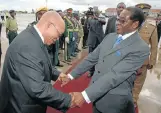  ??  ?? Mugabe says goodbye to then president Jacob Zuma in Harare in 2010 after Zuma helped him resolve factional problems in the Zimbabwe government.