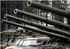  ??  ?? A Russian serviceman stands next to tanks and armoured vehicles at the Army-2015 forum in Kubinka, outside Moscow.