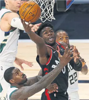  ?? MIKE EHRMANN THE ASSOCIATED PRESS ?? Raptors guard Terence Davis takes a shot against the Milwaukee Bucks on Monday in Lake Buena Vista, Fla. Davis scored 10 points in a 114-106 Raptors win that saw both teams rest star players.