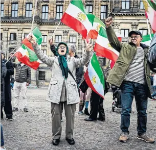  ?? REMKO DE WAAL ANP/AFP VI A GETTY I MAGES ?? Activists attend a demonstrat­ion in solidarity with Iranian women and protesters in Dam Square in Amsterdam on Friday. Canada has hiked economic and immigratio­n sanctions against Iran.