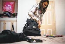  ?? Nathaniel Y. Downes / The Chronicle ?? Alexandra Revelli, head of human resources at Expensify, packs for her fourth trip with the company in San Francisco.