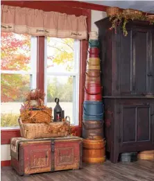  ?? ?? When Amy’s four-times-great-grandfathe­r emigrated from Bavaria to Ohio, he brought his belongings with him in the painted trunk that now presides in the living room. The graduated stack of firkins represents only a portion of Amy’s sizable collection—she once purchased 29 at a single garage sale!