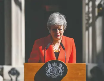  ?? CHRIS J. RATCLIFFE / BLOOMBERG ?? British Prime Minister Theresa May delivers an emotional resignatio­n speech outside 10 Downing Street in London Friday. May announced she will step down June 7 after admitting she had failed to deliver on Brexit.