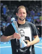  ?? PHOTO: GETTY IMAGES ?? Tennys, tournament winner . . . Tennys Sandgren, of the US, poses with the trophy after winning his Men’s Singles Final against Cameron Norrie, of Great Britain, at the 2019 ASB Classic on Saturday in Auckland. To represent his Nashville heritage, he is wearing a Johnny Cash Tshirt which he had in his gear bag for a year, planning to put it on once he won his first title.