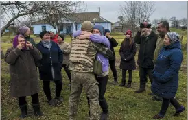  ?? BERNAT ARMANGUE — THE ASSOCIATED PRESS ?? In the village of Vavylove, a Ukrainian serviceman embraces his mother for the first time since Russian troops withdrew from the Kherson region, southern Ukraine, Sunday.