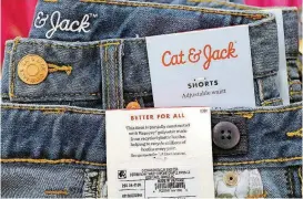  ?? [AP PHOTOS] ?? Cat & Jack jeans, on display at a Target store in New York, are made with Repreve polyester fabric, created from recycled plastic bottles. For this year’s back-to-school shopping season, parents and their kids are looking for second-hand clothing or...